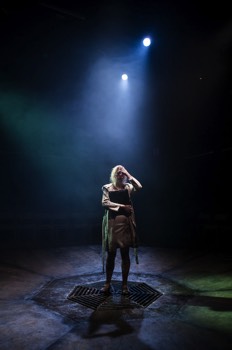  Fay (Rebecca Humphries) stands in the centre of the stage clutching a laptop. 
