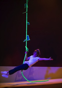 Purple Snowflakes and Titty Wanks Production Image. Saorise (Sarah Hanley) swinging on a neon green beanstalk rope.
