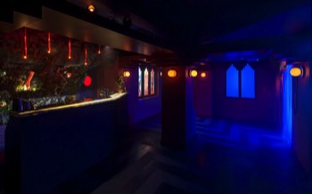 A wide shot of the bar floor area. Bar to the left and cloud room filled with vaporised gin and tonic at the far end.